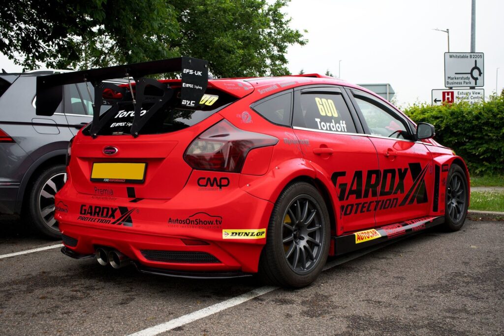 Dynamic image of a red Ford Focus RS racecar parked in Whitstable, UK.