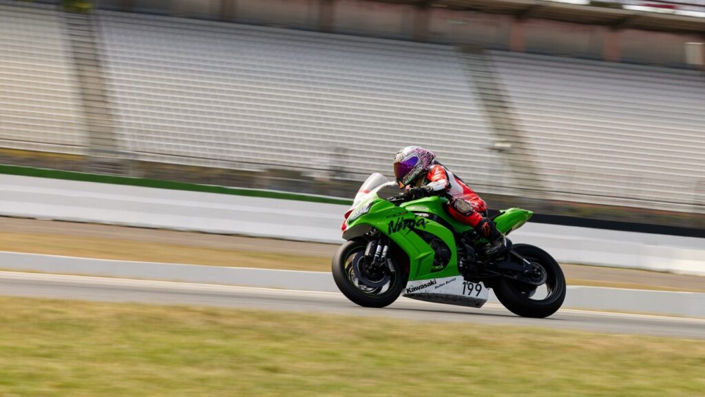 Professional motorcycle racer speeding at Hockenheimring in Germany. High-speed sports action captured outdoors.